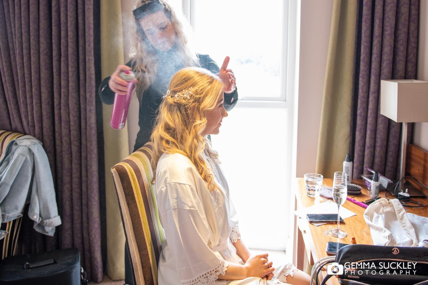 hairdresser spraying hairspray on a bride at coniston hotel