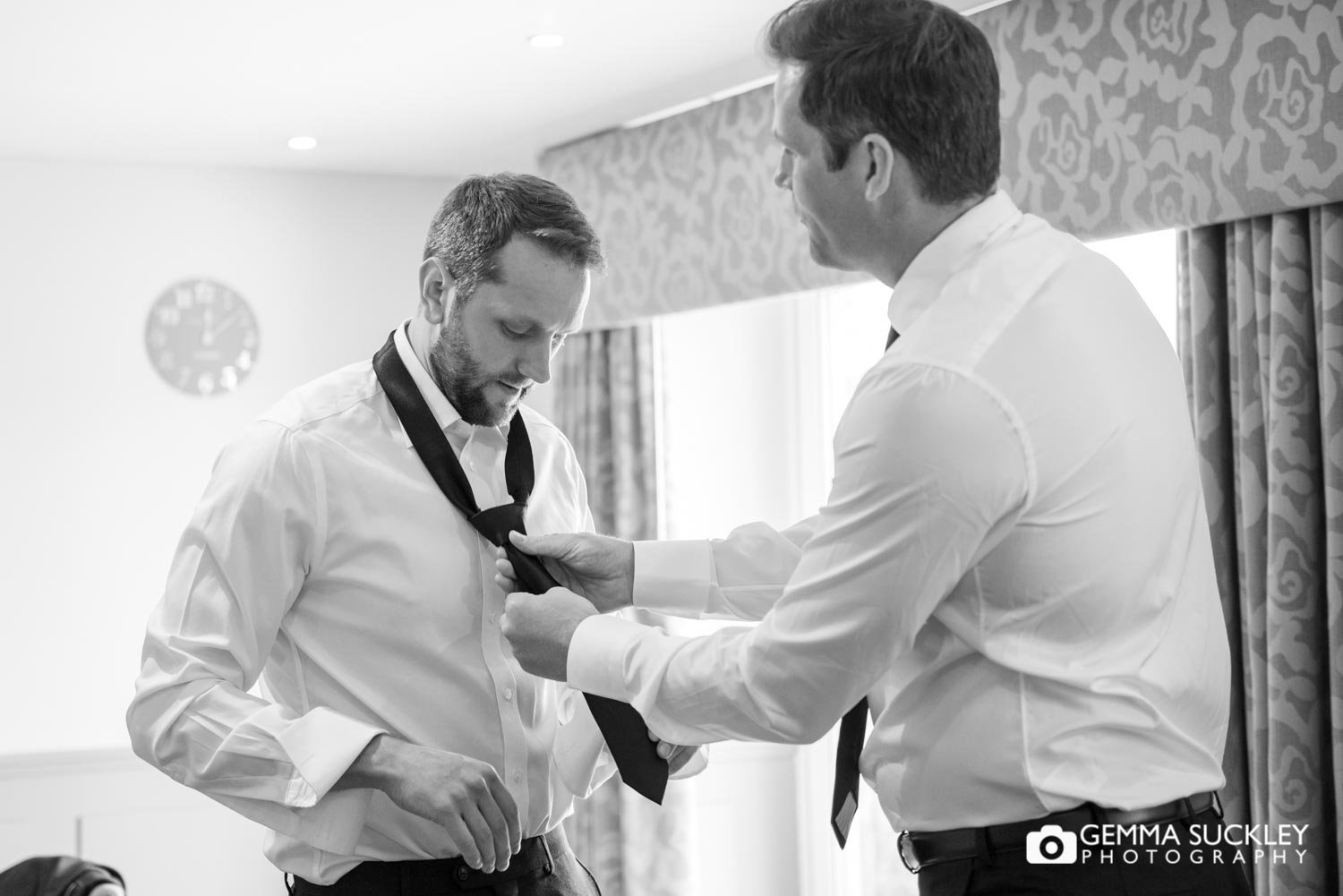 bestman putting the tie on at coniston hotel skipton