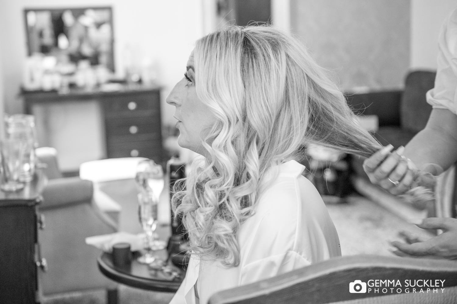 bride getting her hair curled 