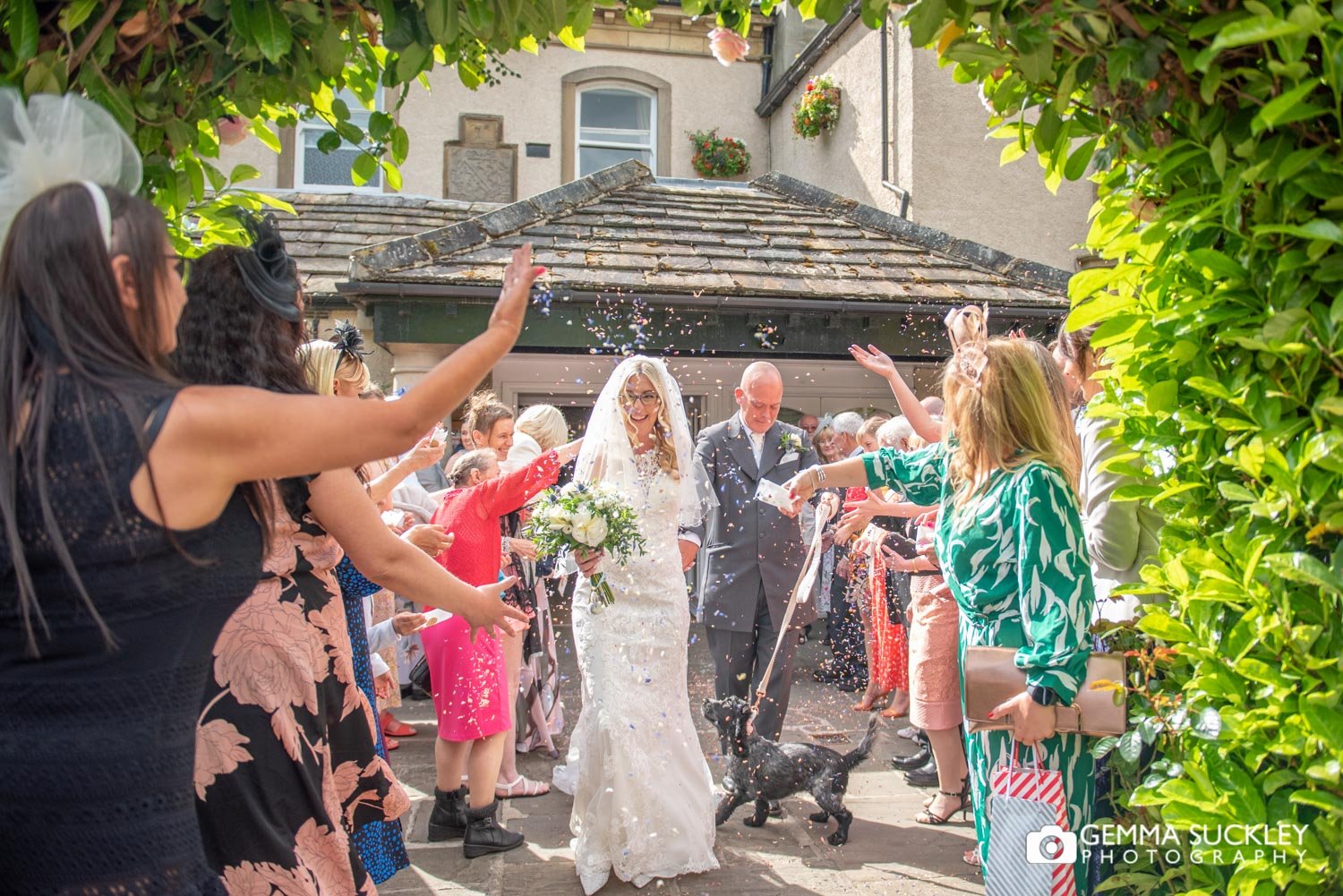 wedding guests throwing confetti outside steeton hall