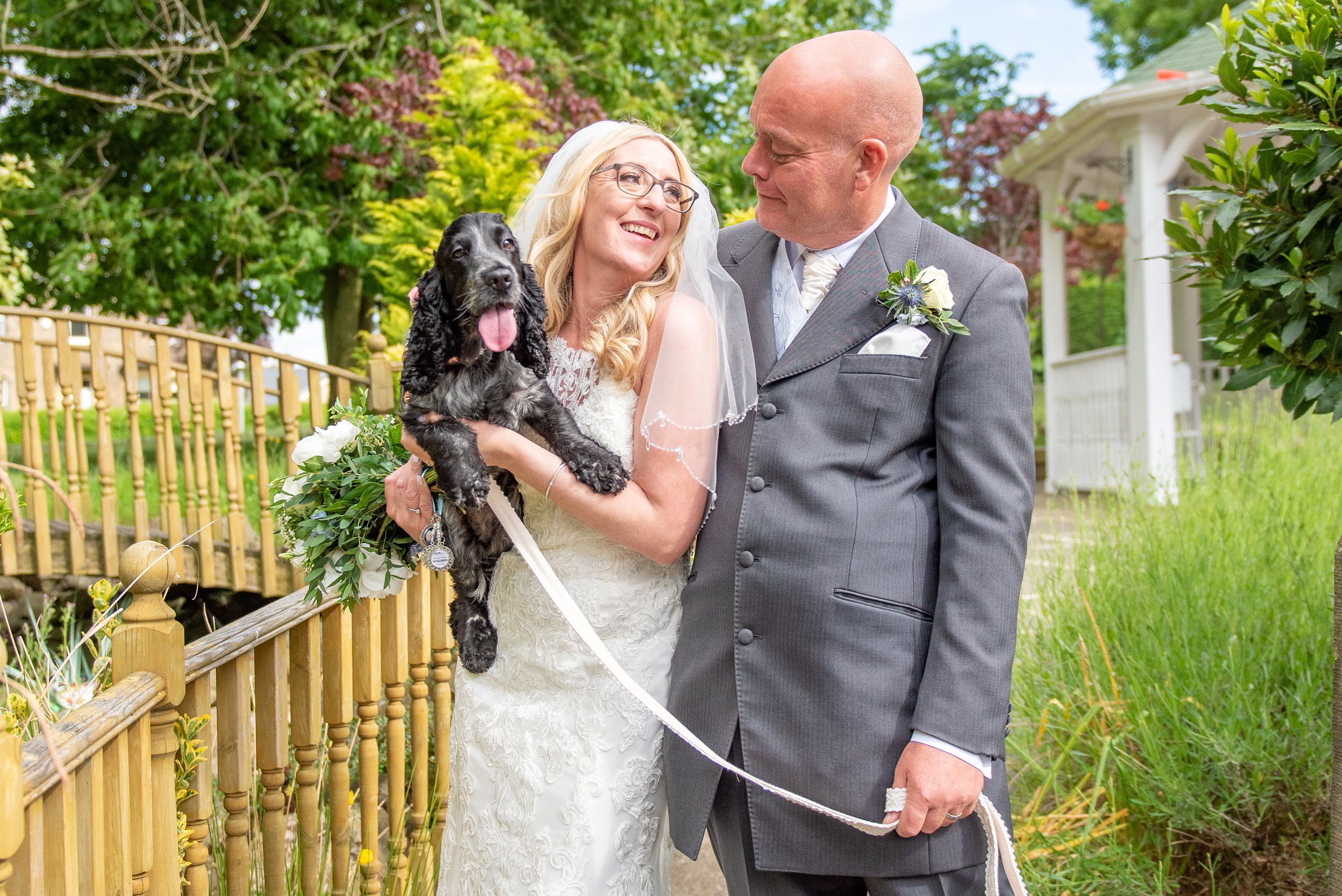 bride and groom with their dog at their steeton wedding