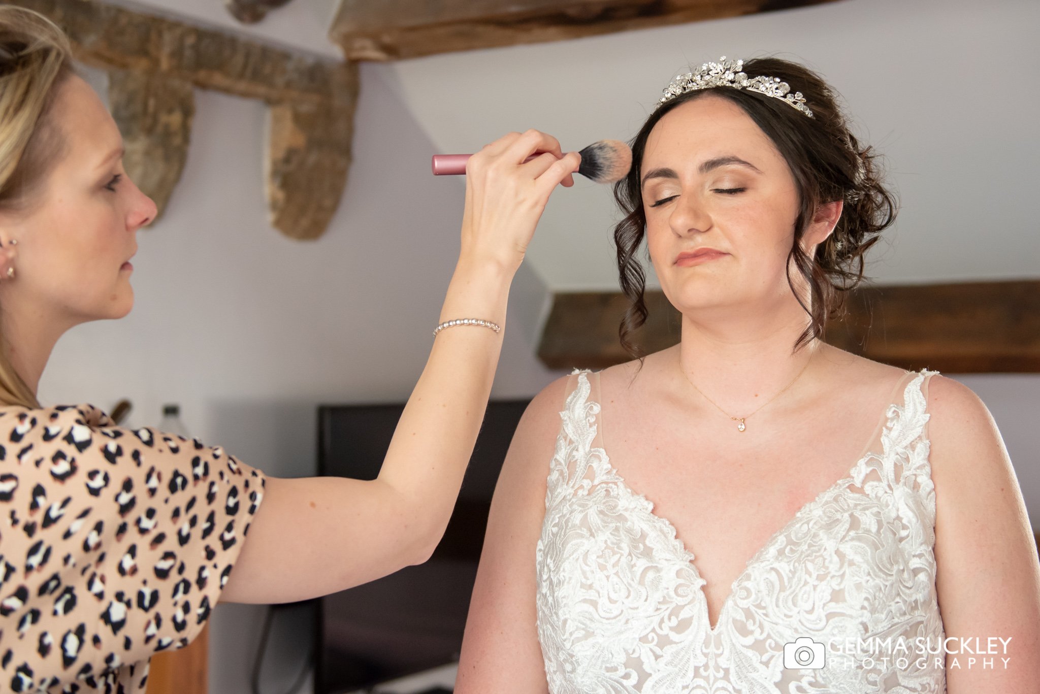 makeup bring applied to the bride