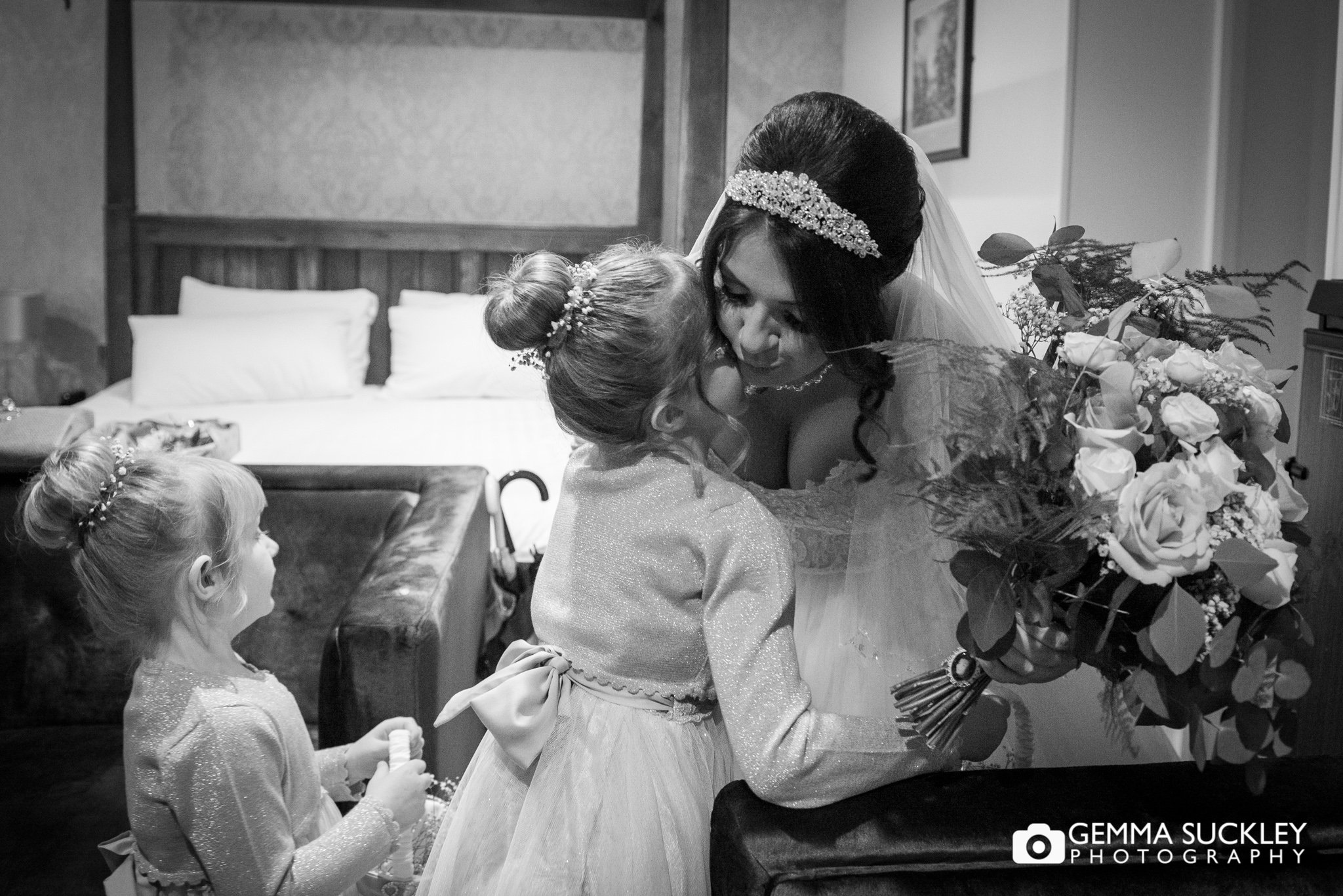 flower girl hugging the bride