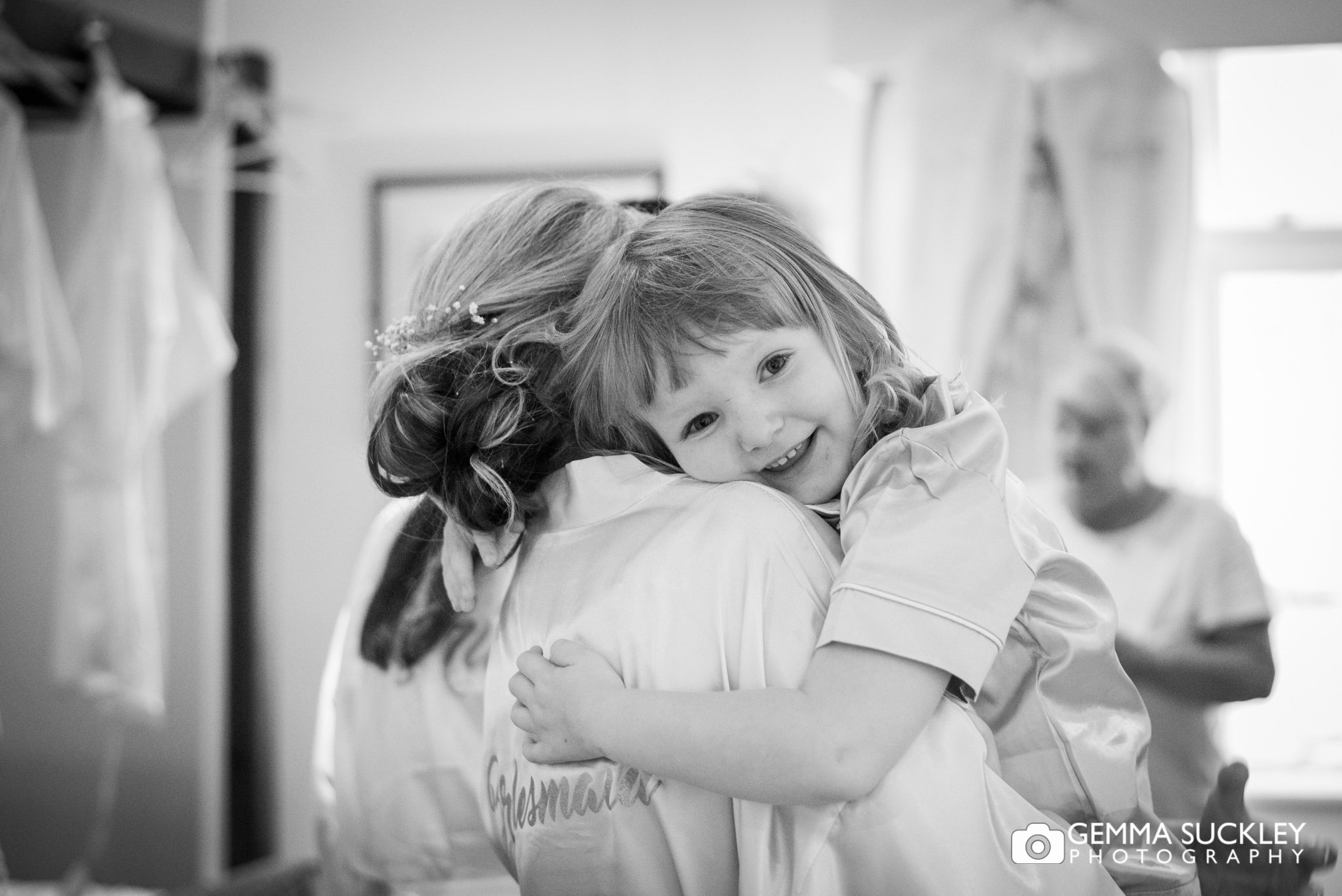 flower girl hugging the bridesmaid at hollins hall