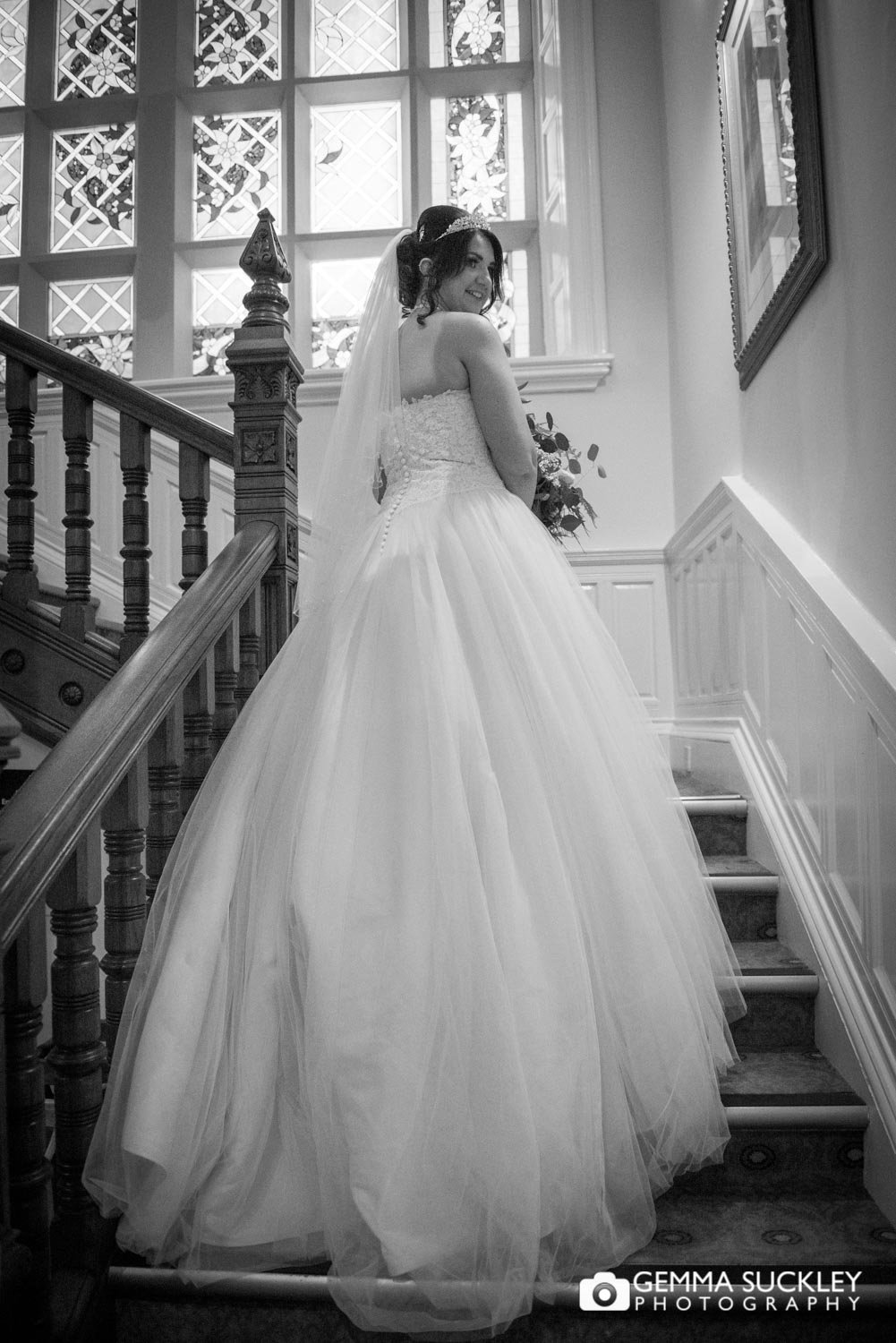 the bride showing off her dress at hollins hall hotel in baildon