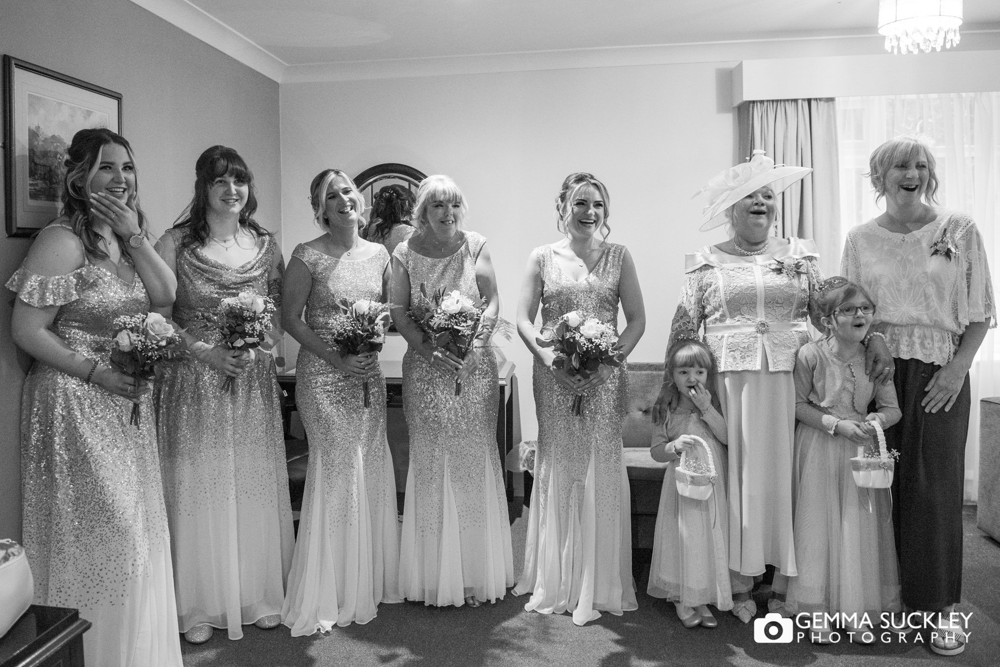 bridesmaids and flower girls seeing the bride for the first time at hollins hall