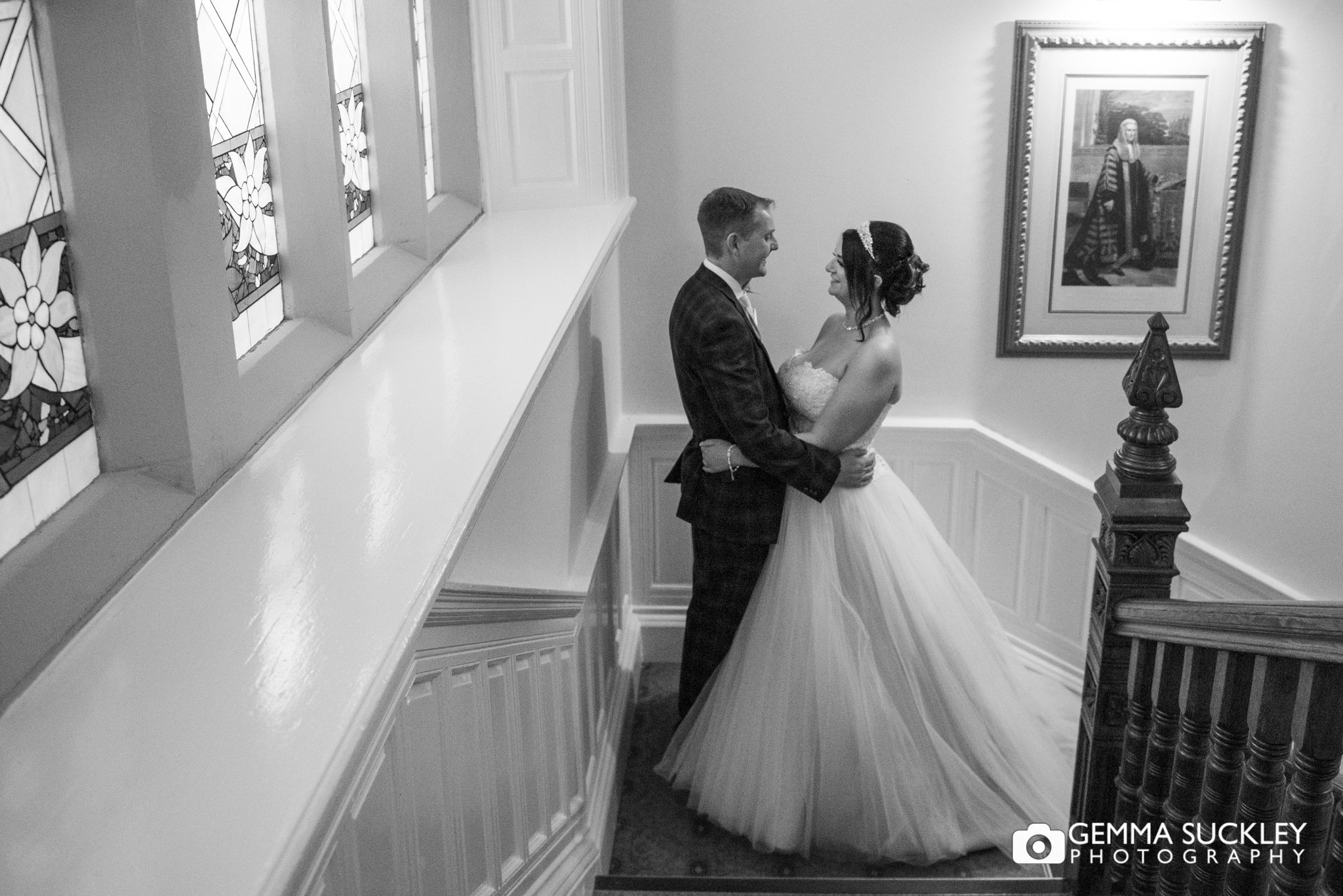 bride and groom on the stairs at hollins hall hotel