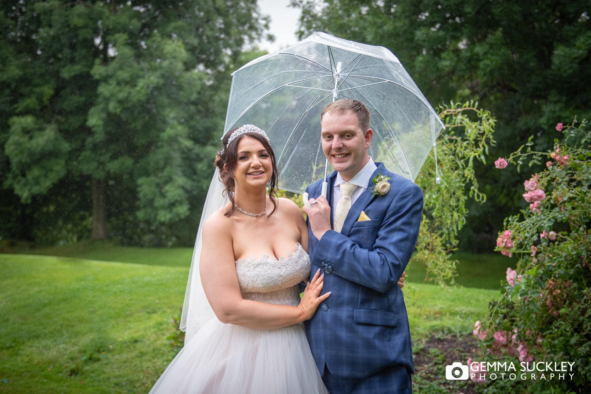 bride and groom wedding portrait while it rains at hollins hall