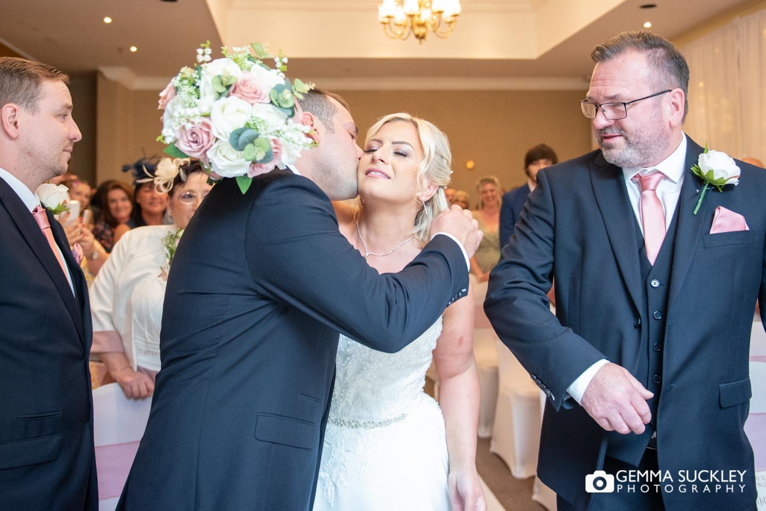 the groom kisses his bride at hollins hall