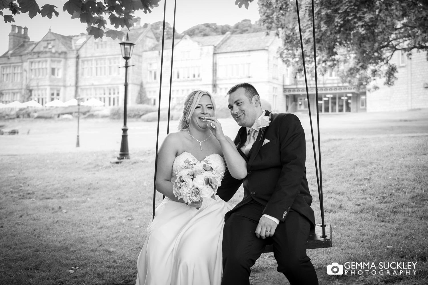 bride and groom laughing on the swing at hollings hall