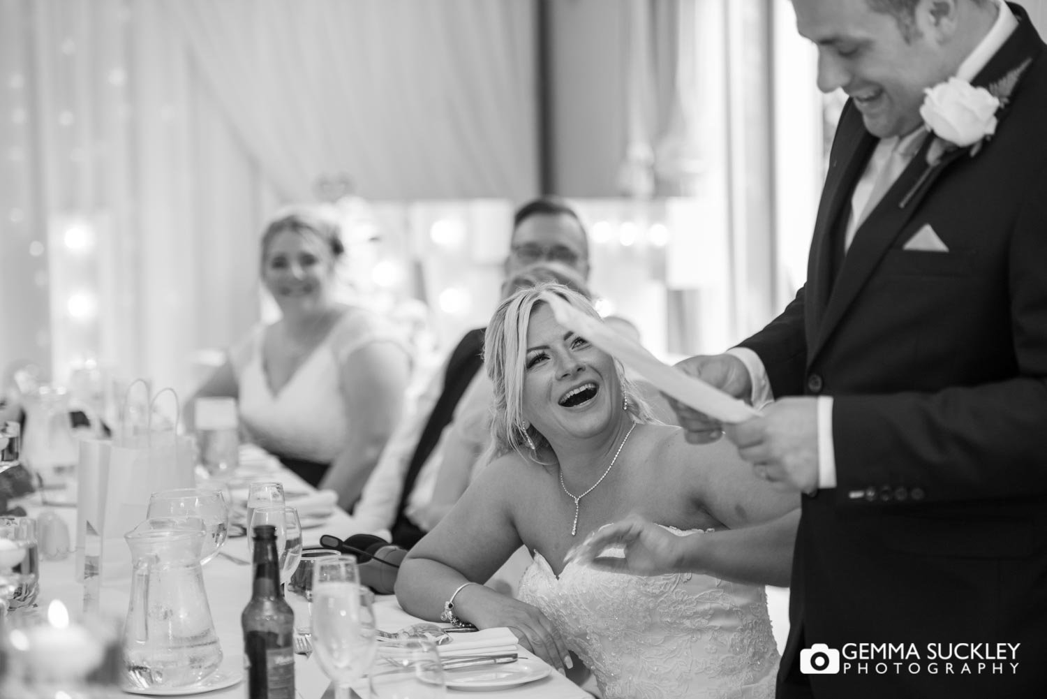 the bride laughing at the grooms speech