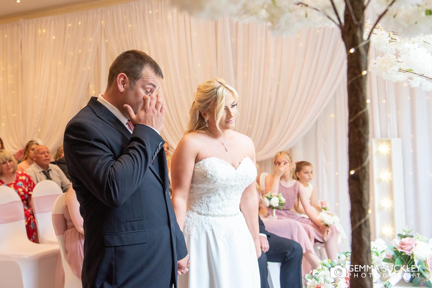 the bride and groom holding hands at their hollins hall wedding ceremony