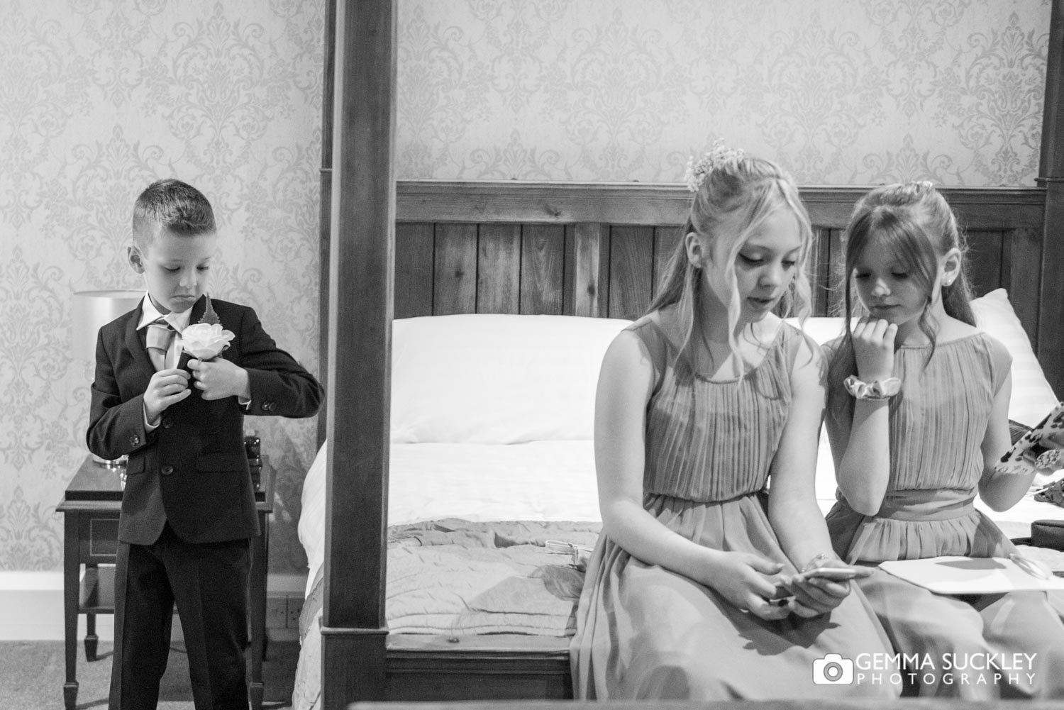 two young bridesmaids sat on a bed at hollins hall