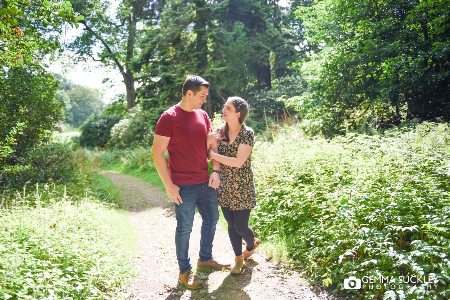 couple walk through the woods at swinton park estate