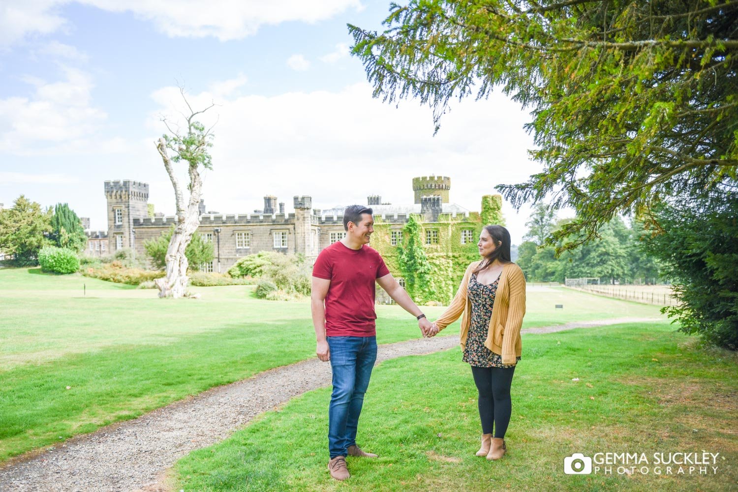 engaged couple holding hands in front of swinton park hotel