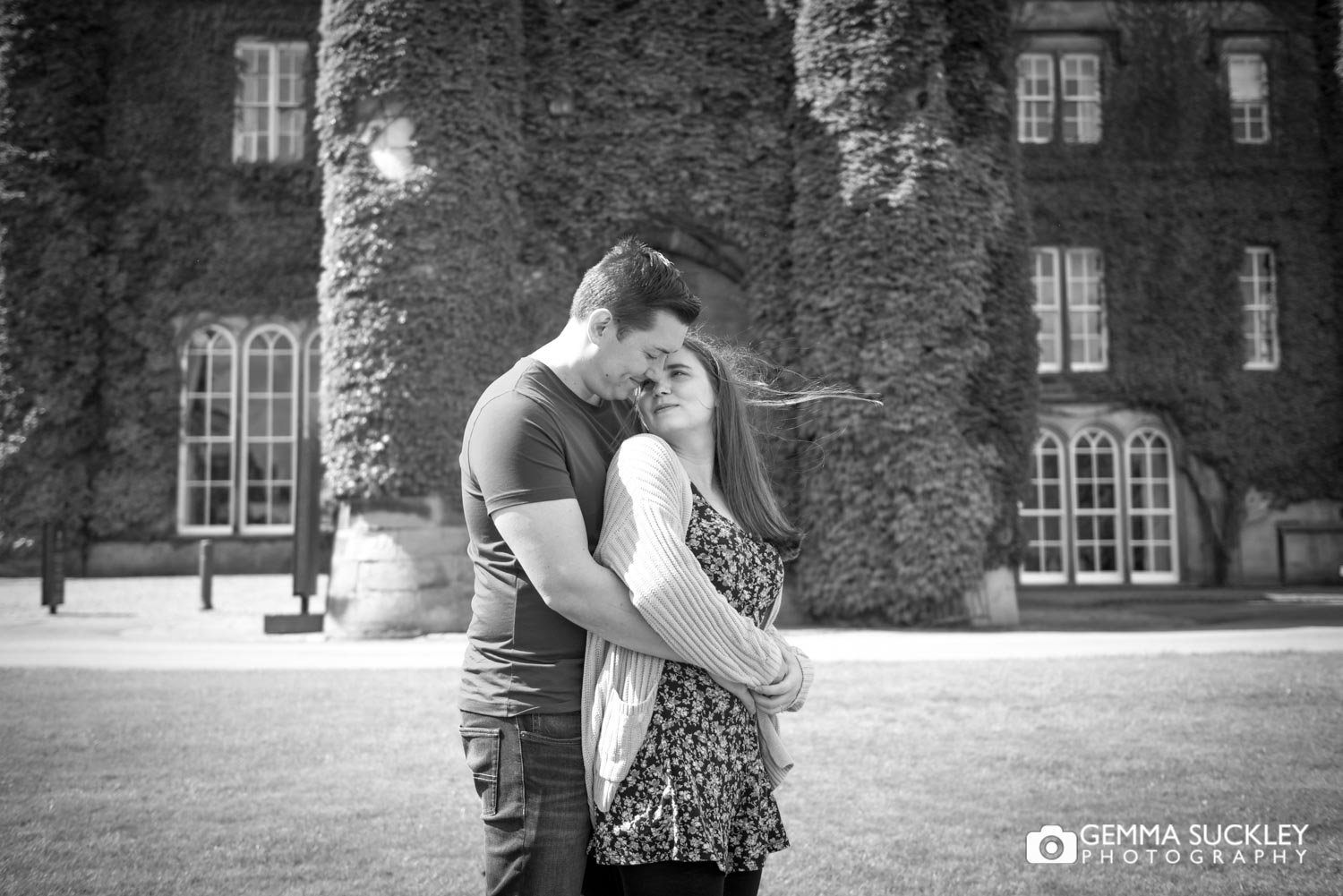 engaged couple hugging in front of swinton park hotel