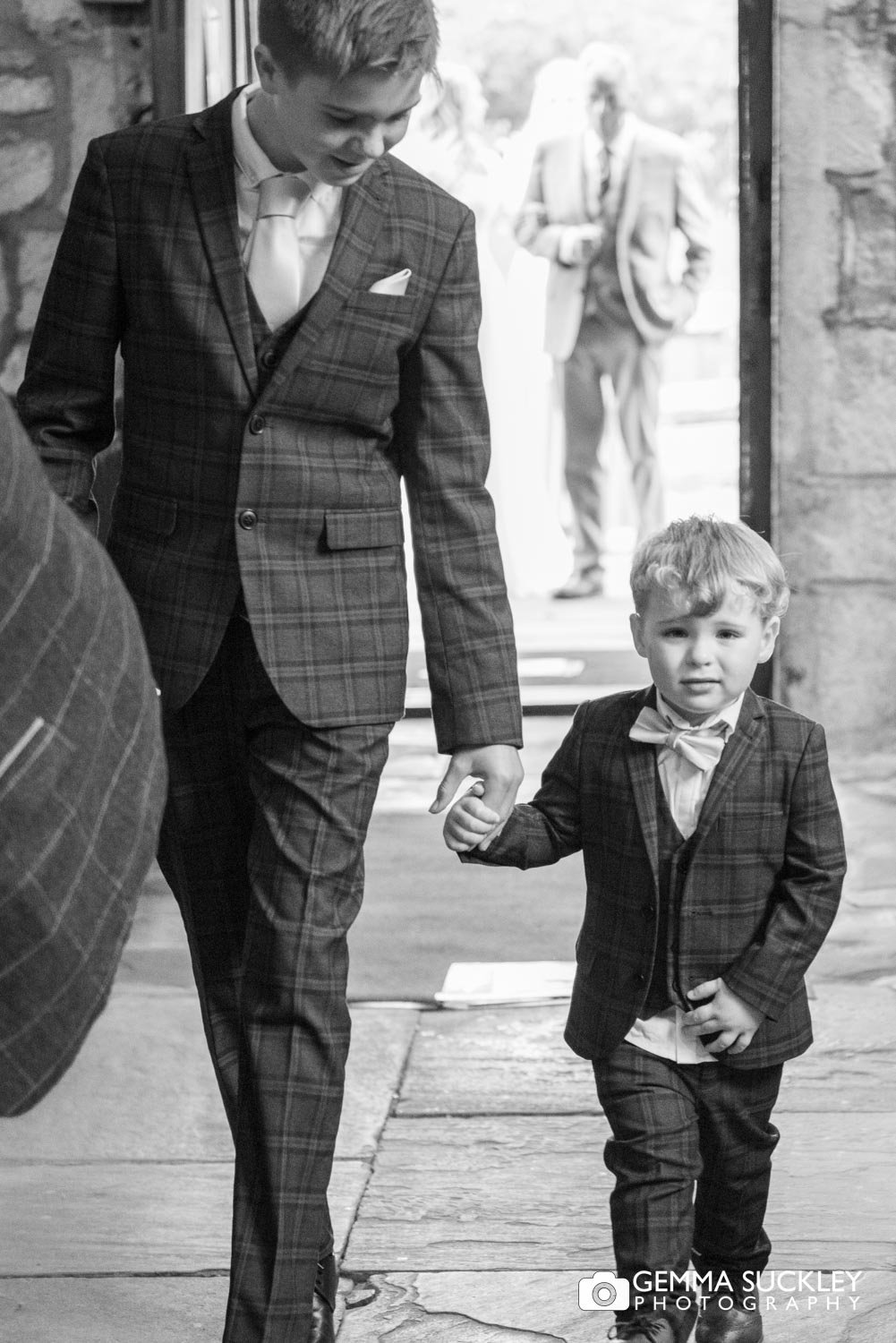 two page boys entering the church at linton in North yorkshire