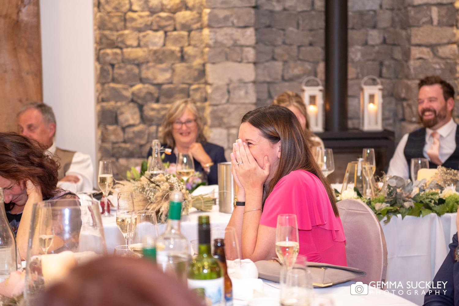 wedding guests laughing at speeches