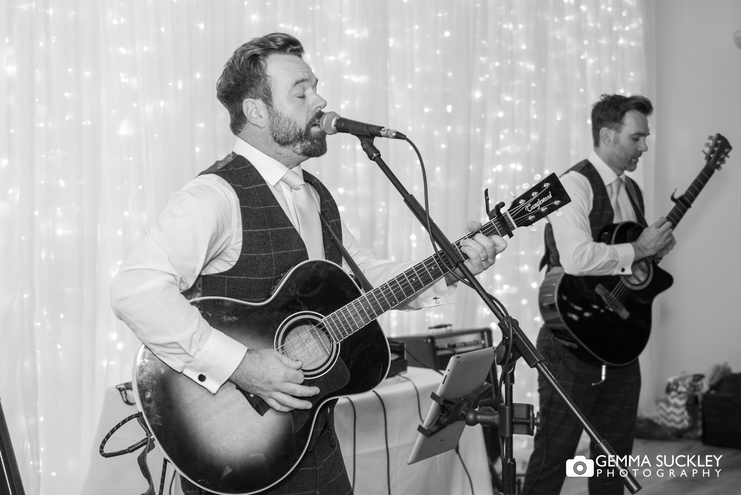 the groom playing the guitar at his wedding