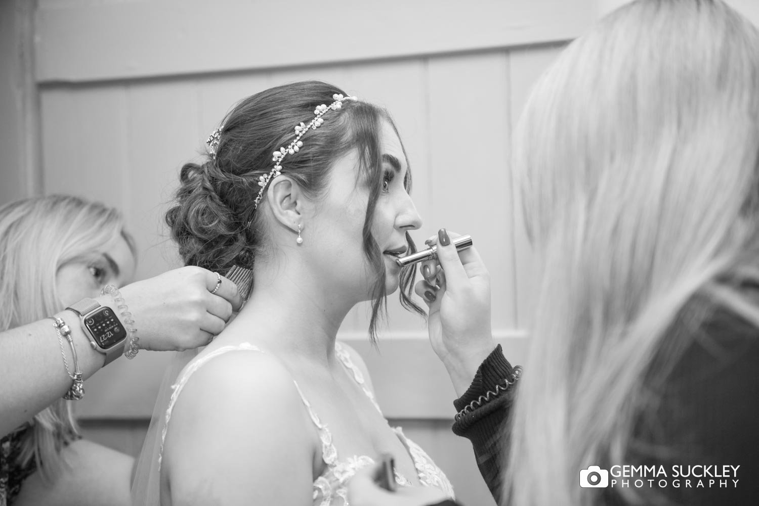 lipstick being applied to the brides