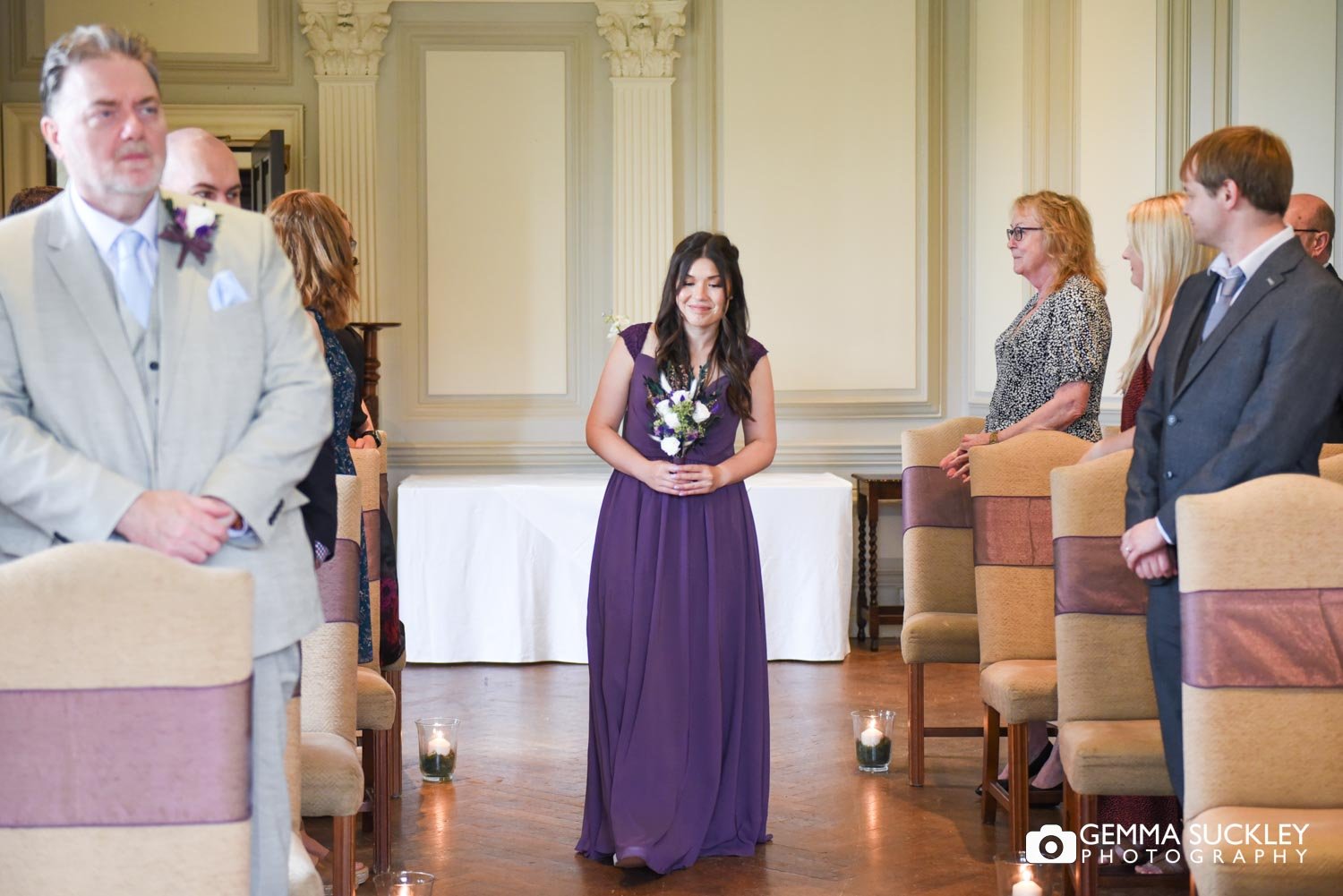 a bridesmaid walking down the aisle 