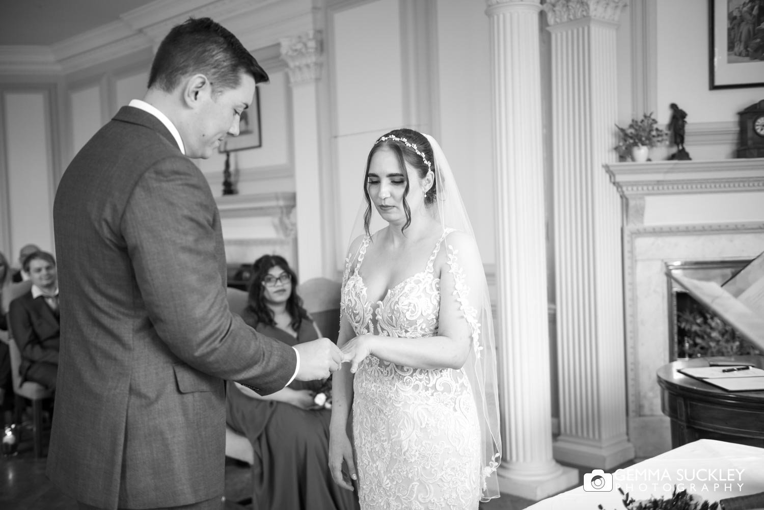 the groom putting the ring on his bride