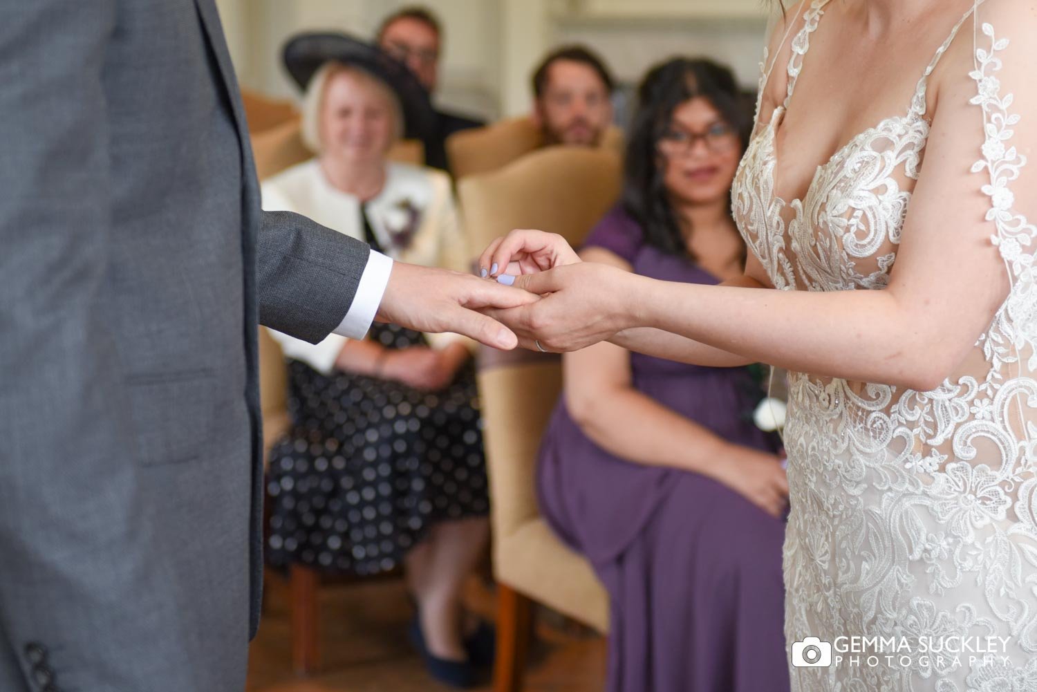 the bride putting the ring on her groom