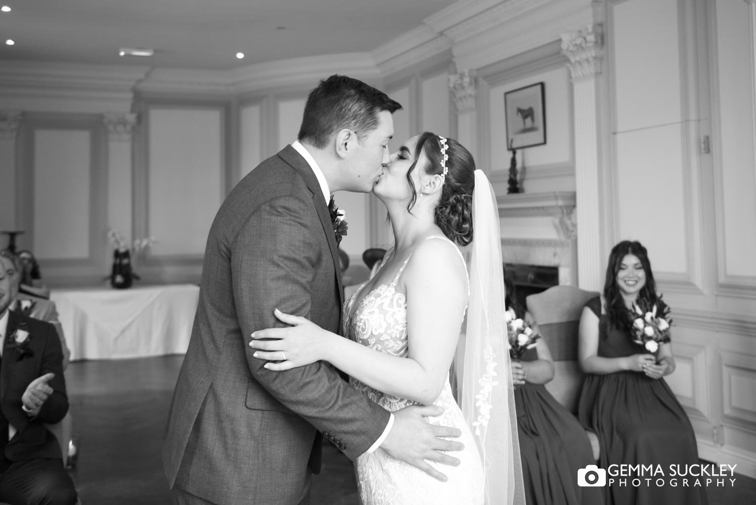 bride and groom kiss during their wedding ceremony