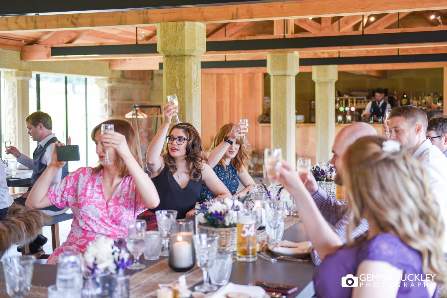 wedding guests cheering at speeches at the deer house