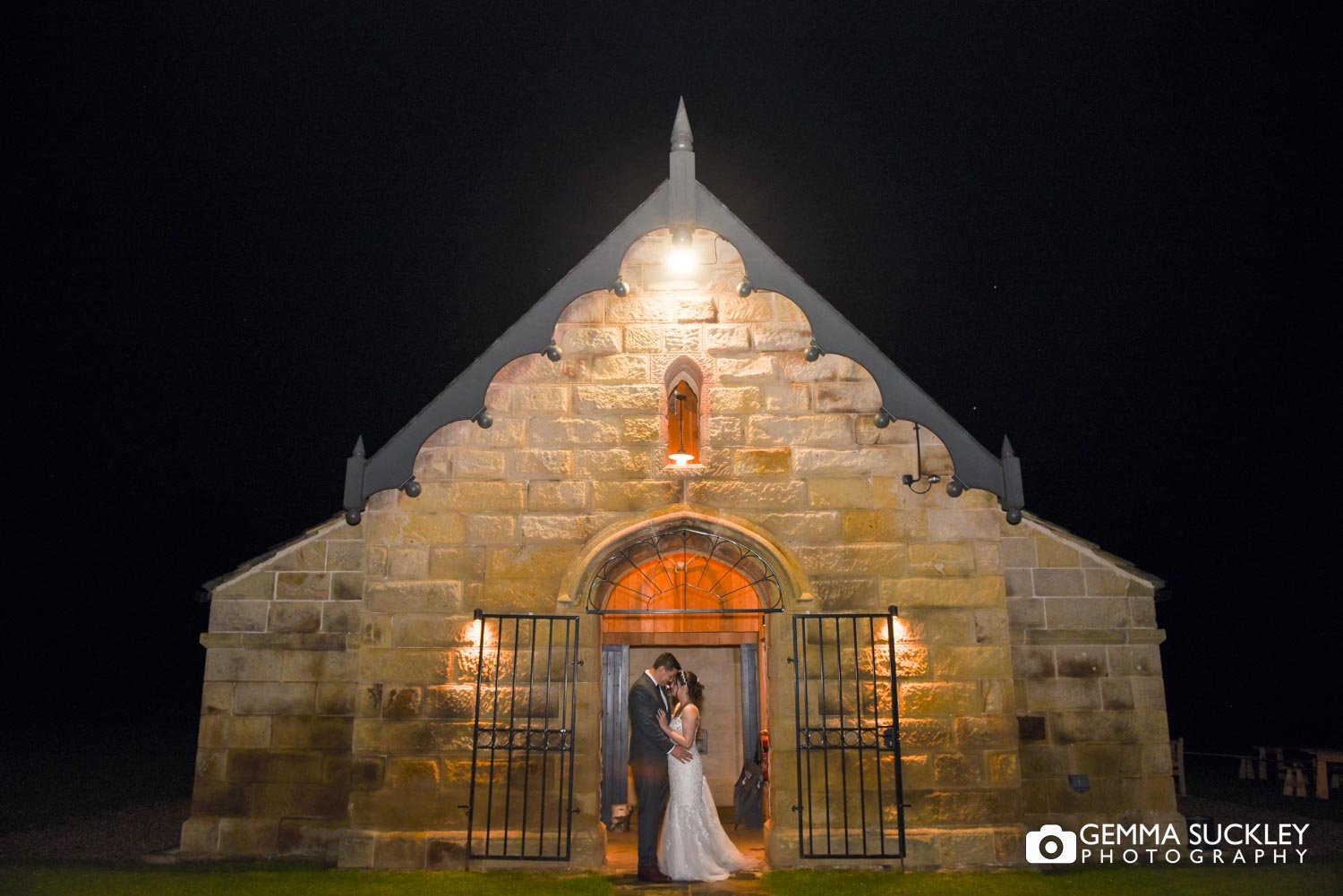 bride and groom outside the deer house at swinton park at night