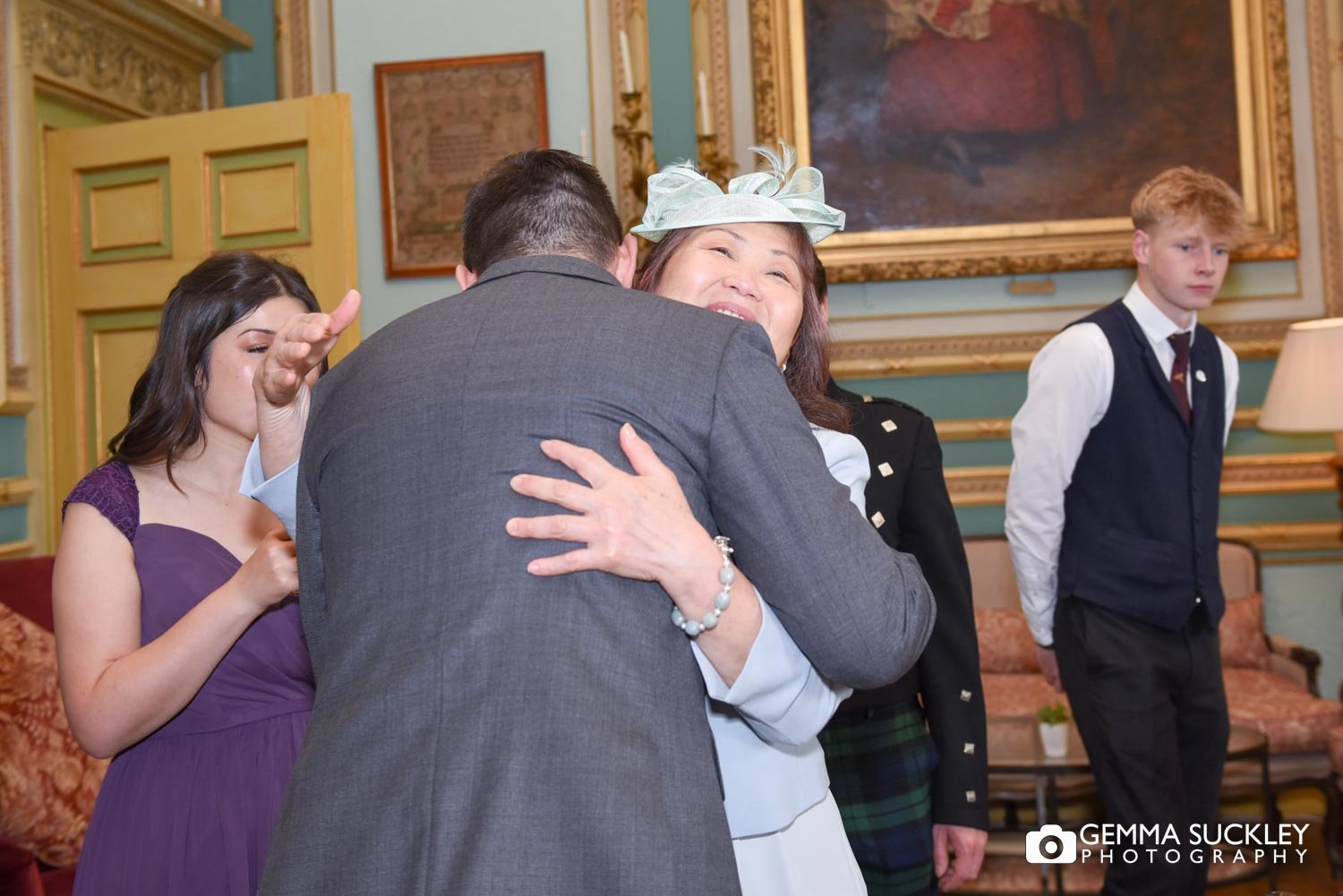 groom hugging his mum in the during room at swinton park