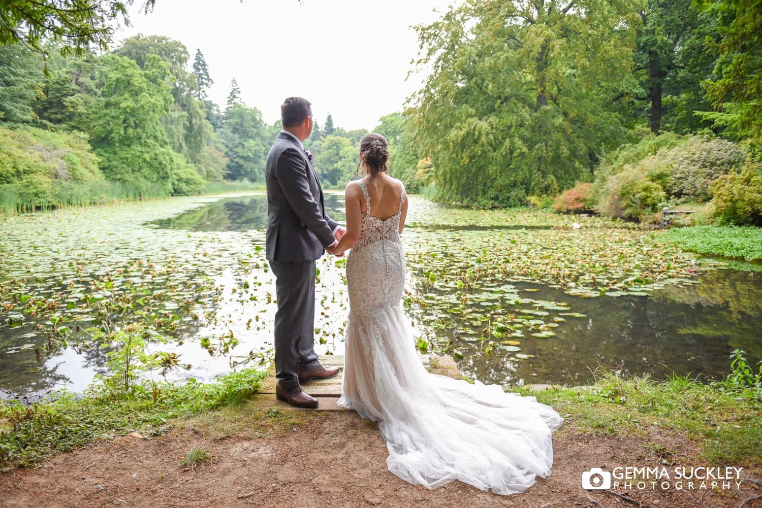 newlyweds looking out at coffin lake on swinton park