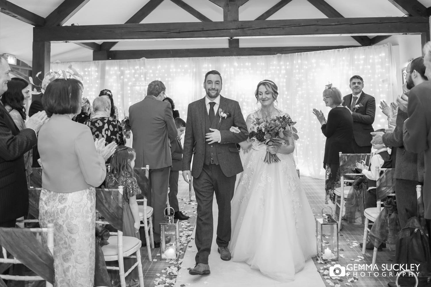 bride and groom exiting the wedding ceremony at coniston hotel