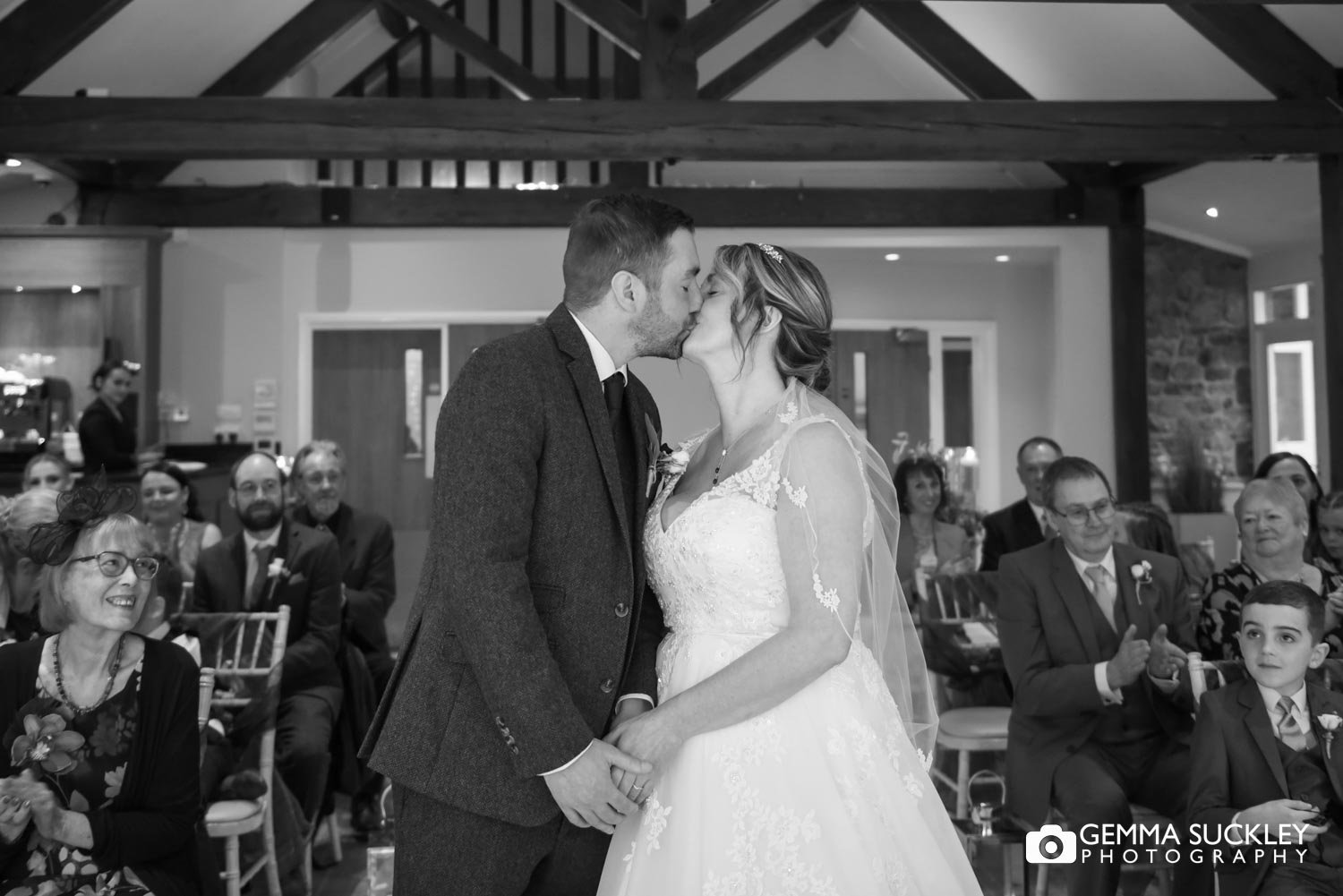 the bride and groom kissing after the wedding ceremony