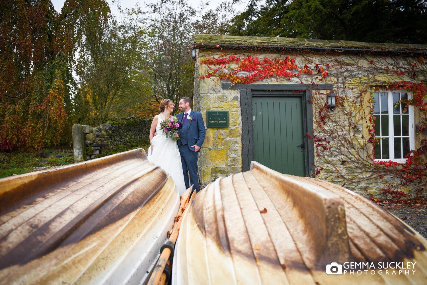 the bride and groom at the boat house at conison lake in skipton