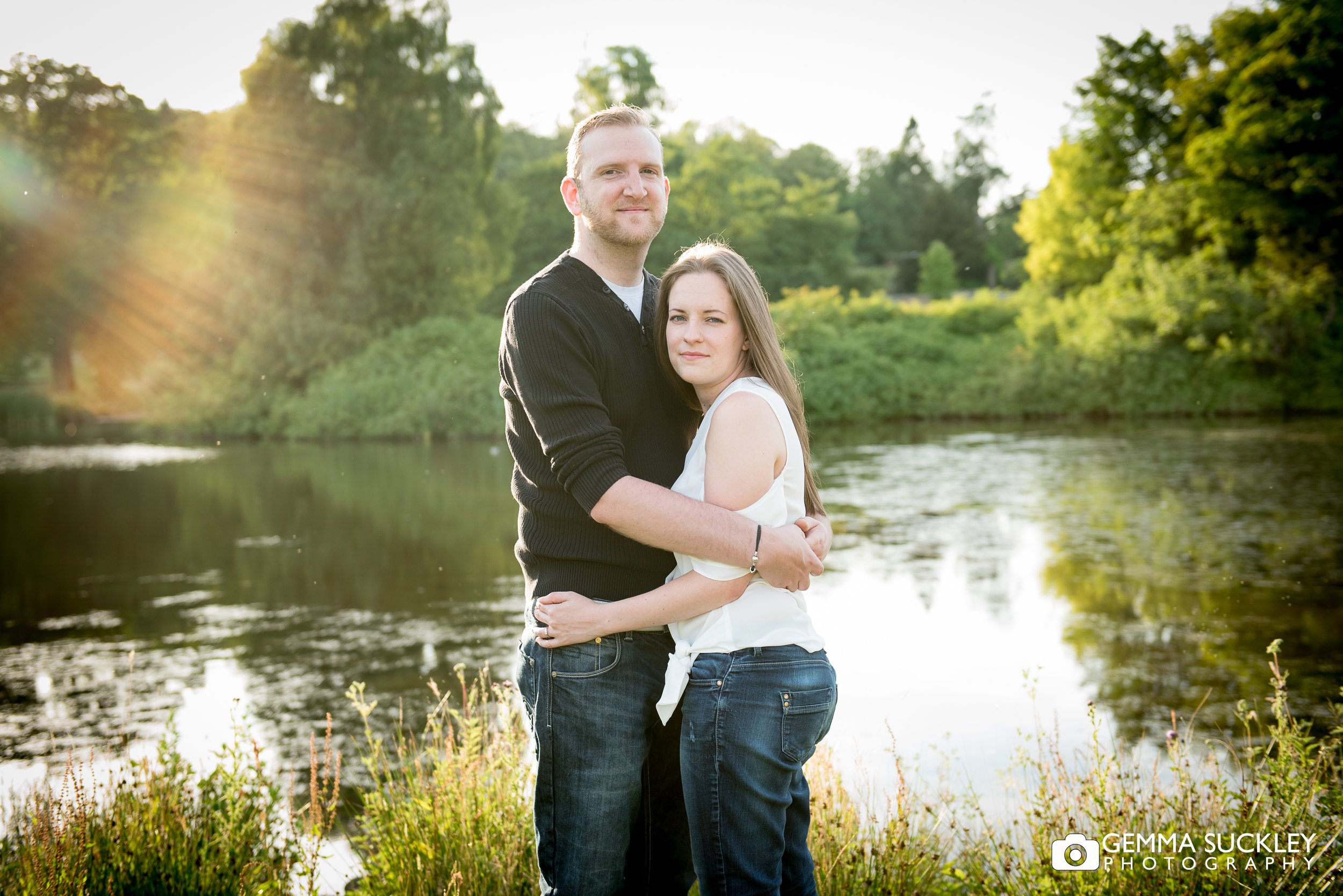 an engaged couple hugging at golden hour at coniston hotel lake