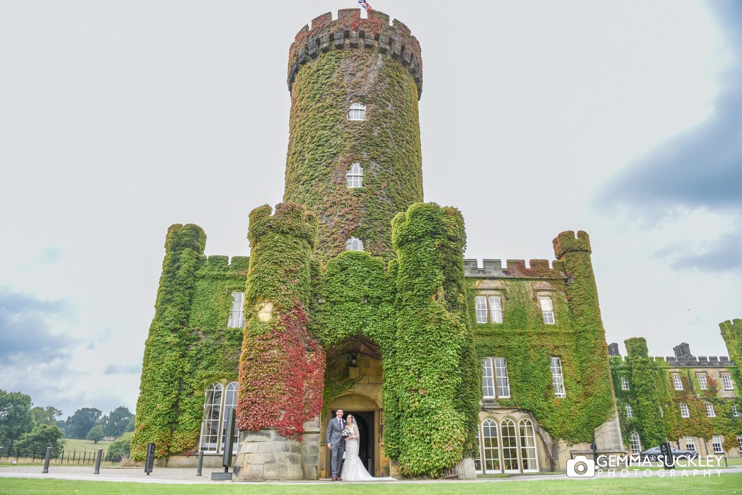 bride and groom in front of swinton castle