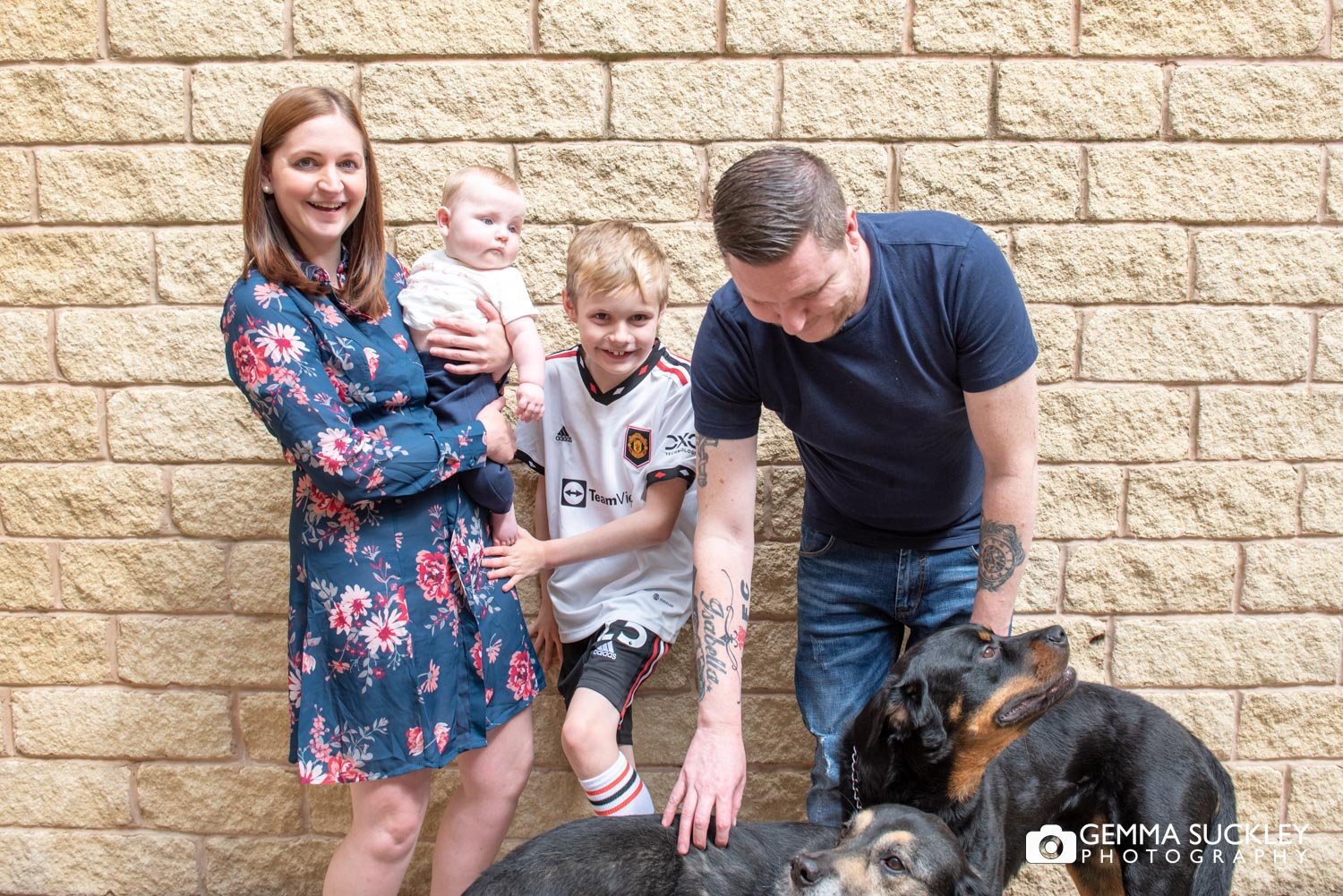 a family laughing at their dogs
