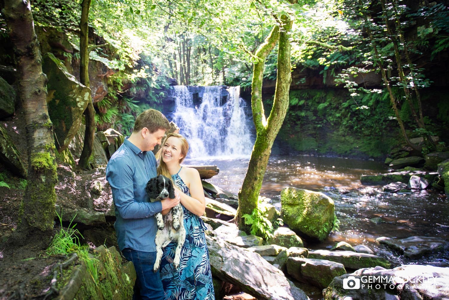 engaged coupe hugging their puppy at cullingworth waterfall
