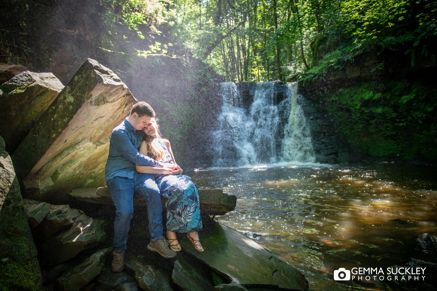 engaged couple hugging in front of the  Goitstock waterfall