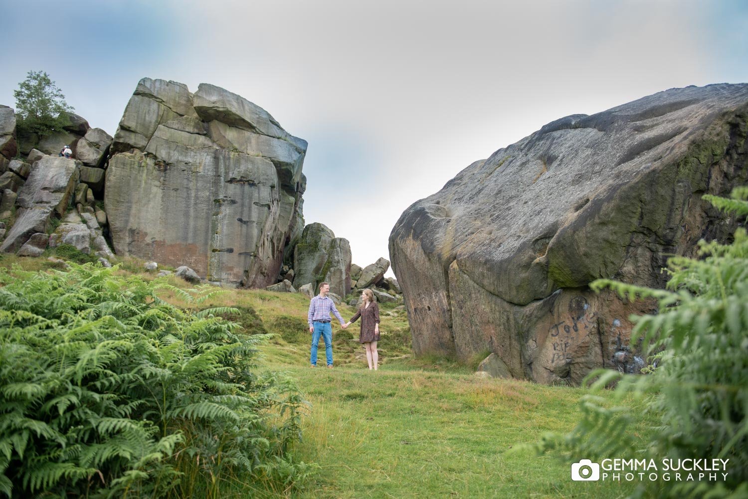 enaged couple in front of the cw and calf in ilkley