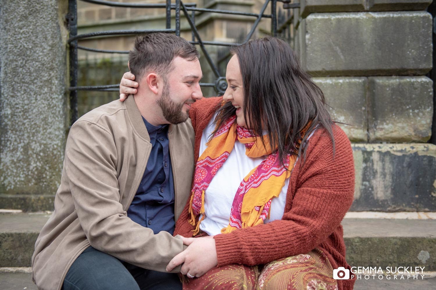 engaged couple looking lovingly into each others eyes 