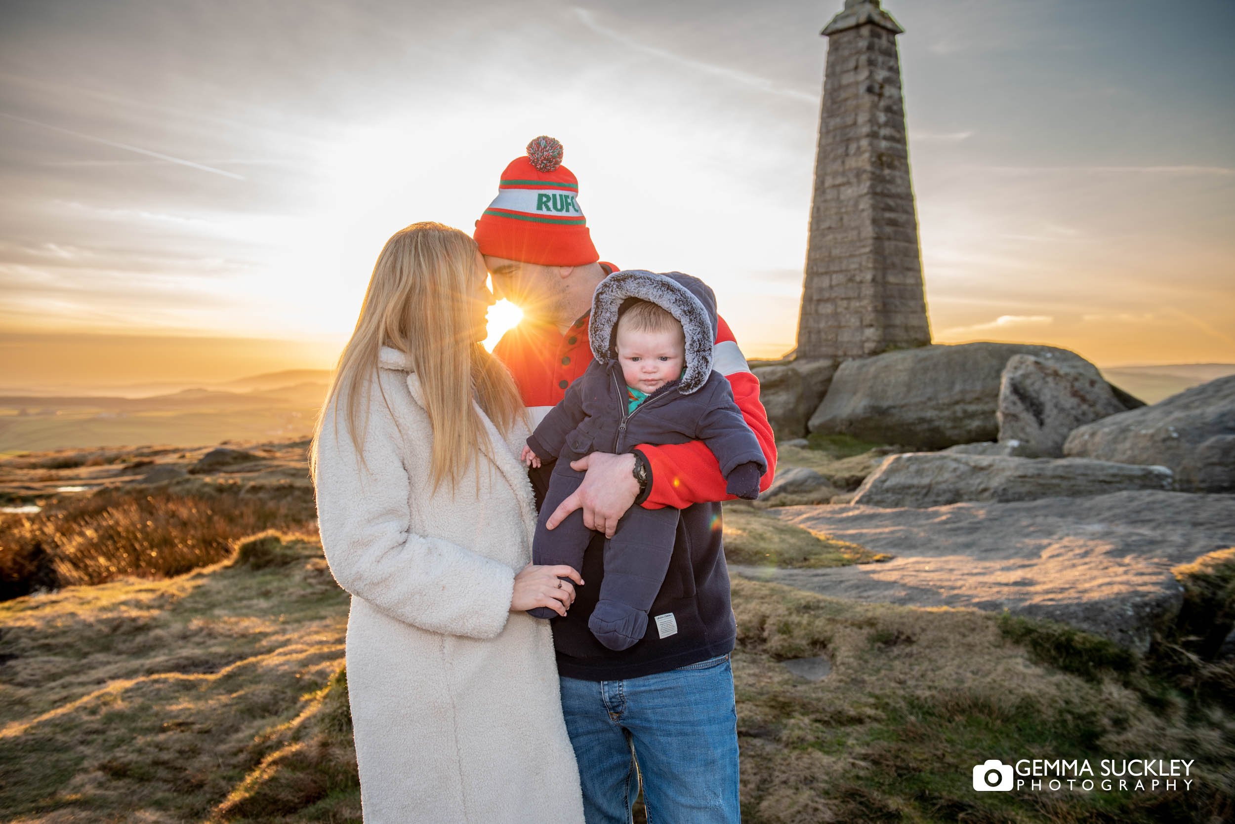 an engaged couple with the baby at cowling pinnacle during sunset 