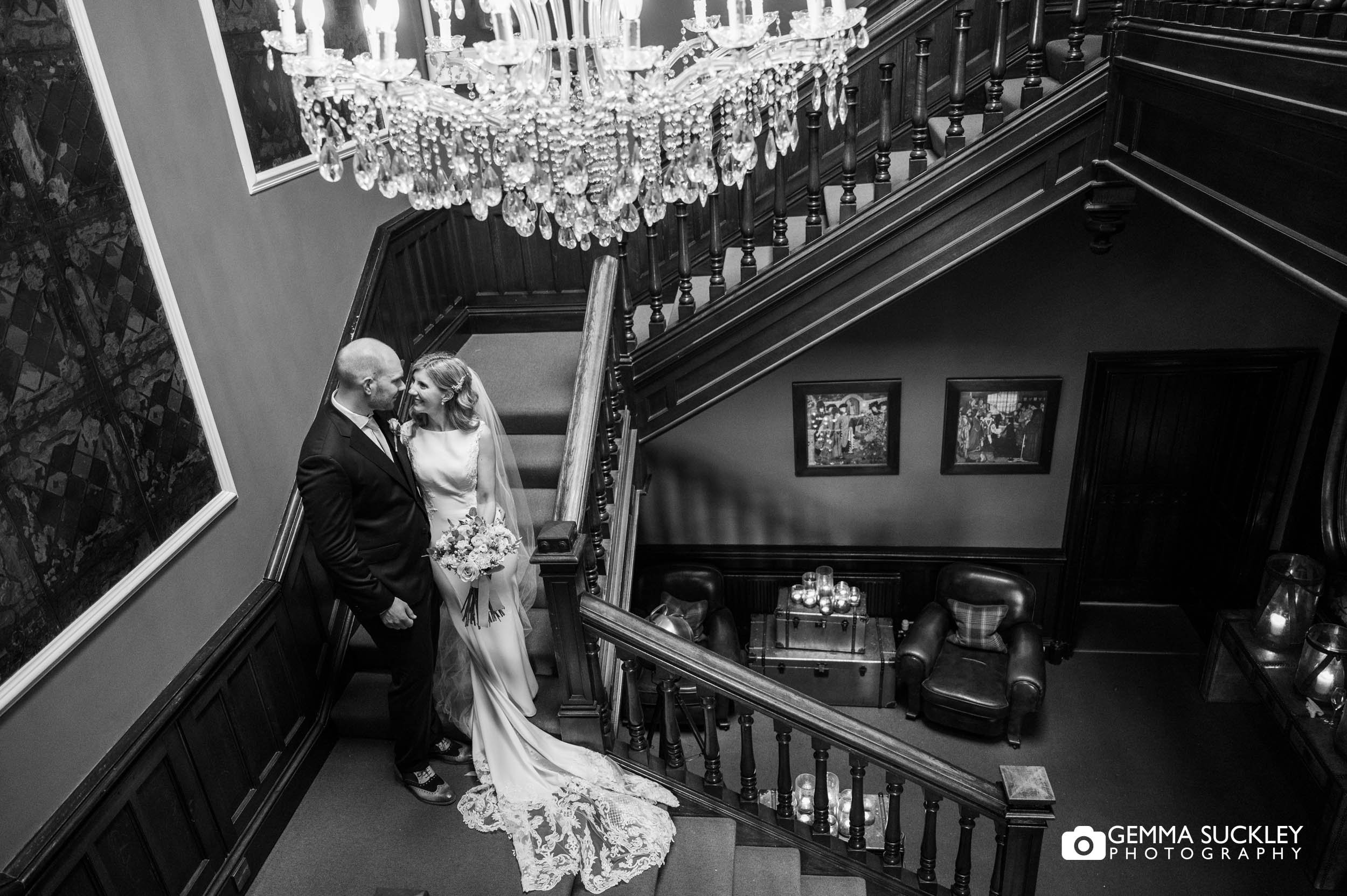 bride and groom hugging on the stairs at falcon manor