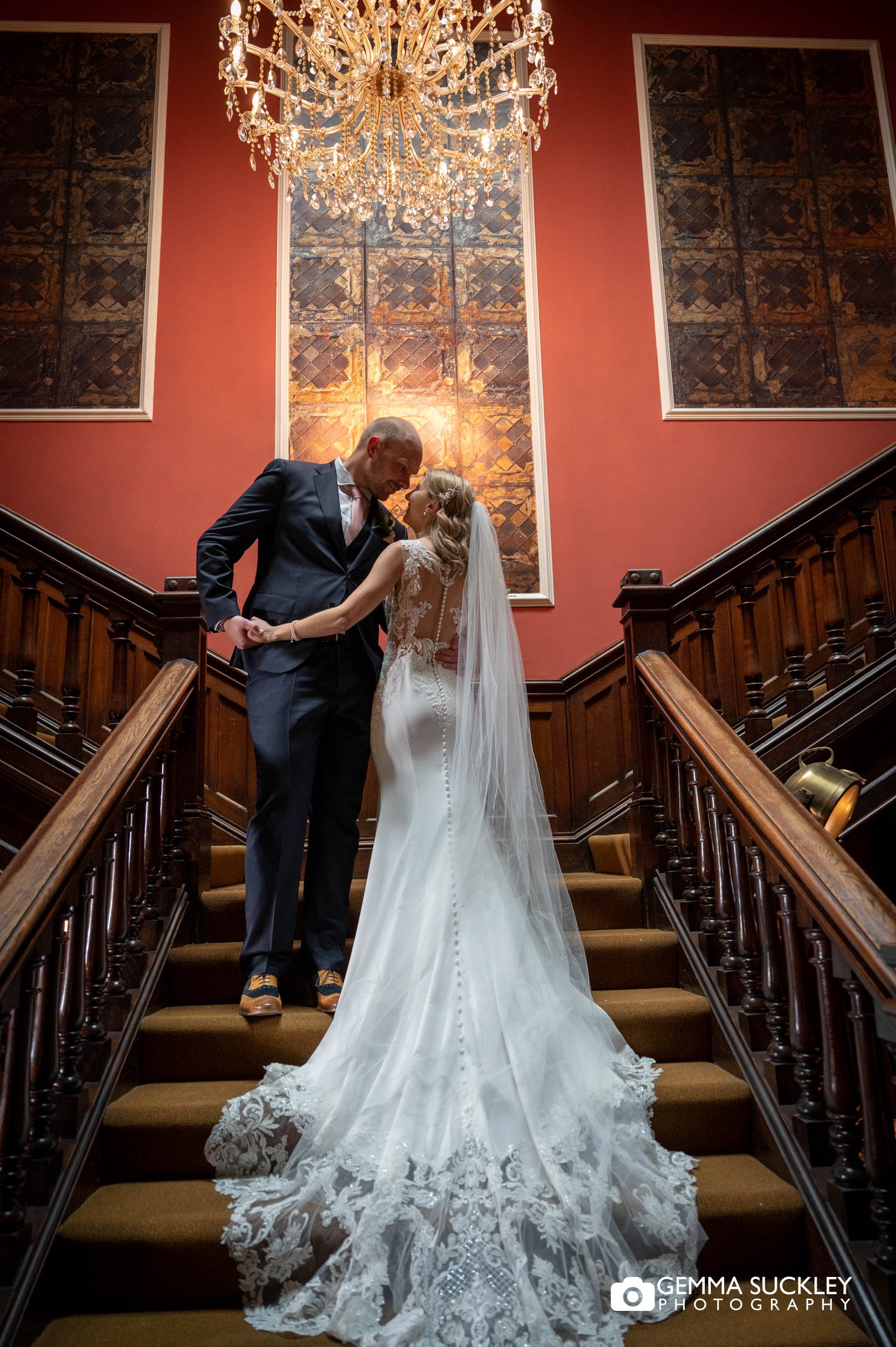 bride and groom on the staircase at the falcon manor