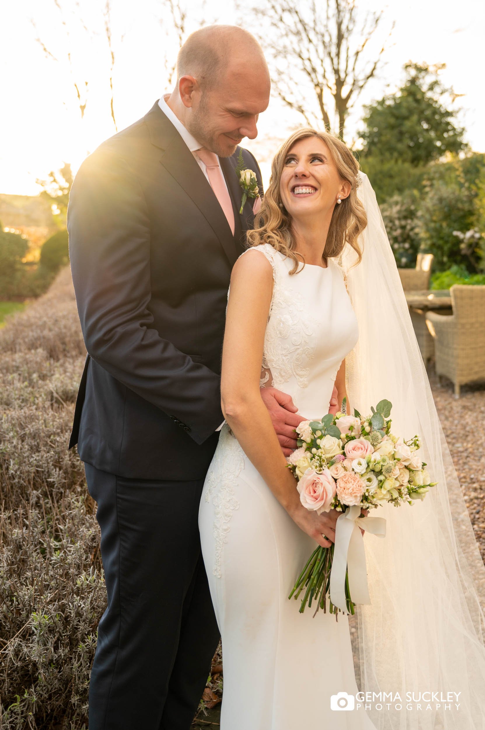 bride and groom outside the falcon manor at golden hour