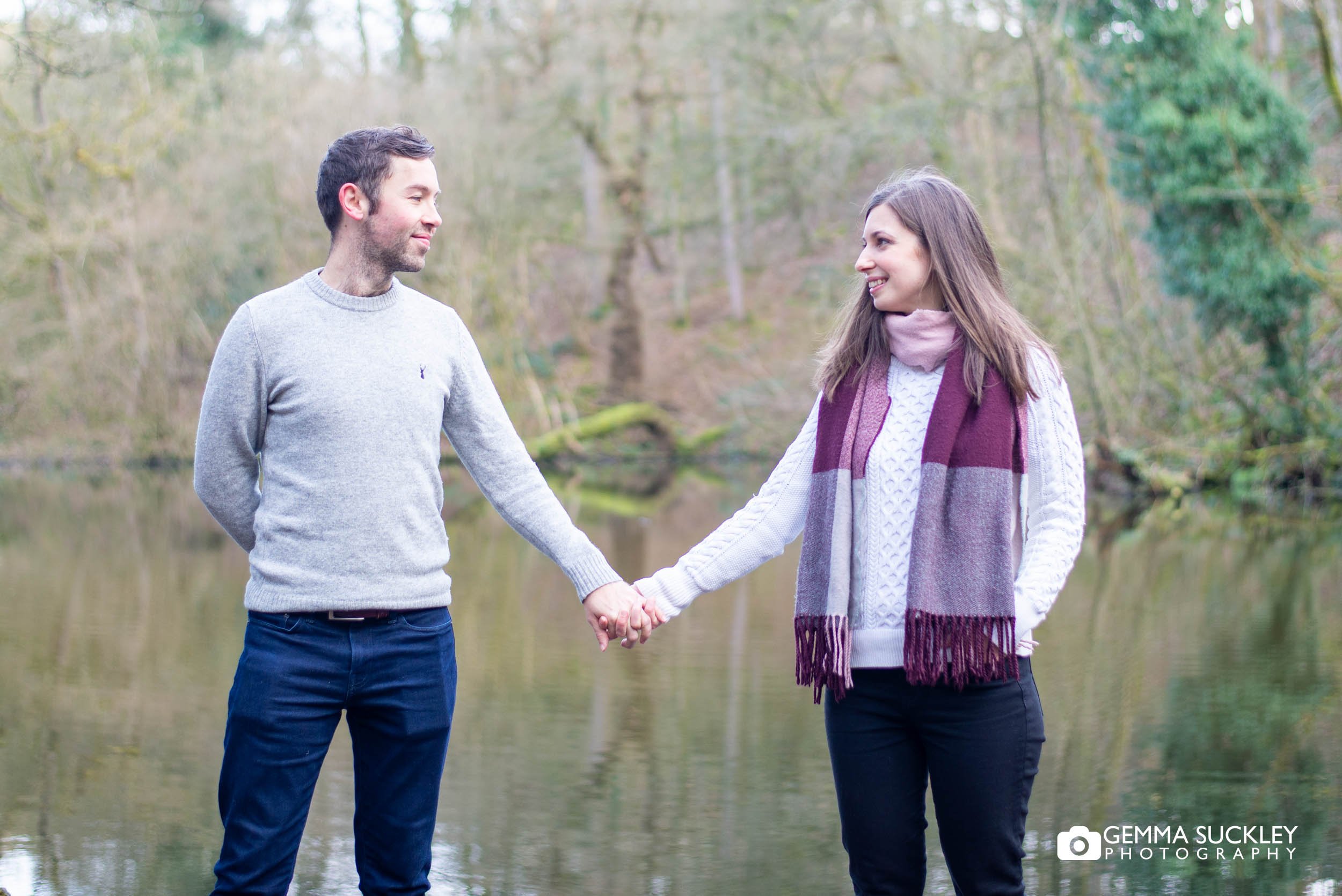 engaged couple holding hands in skipton wood