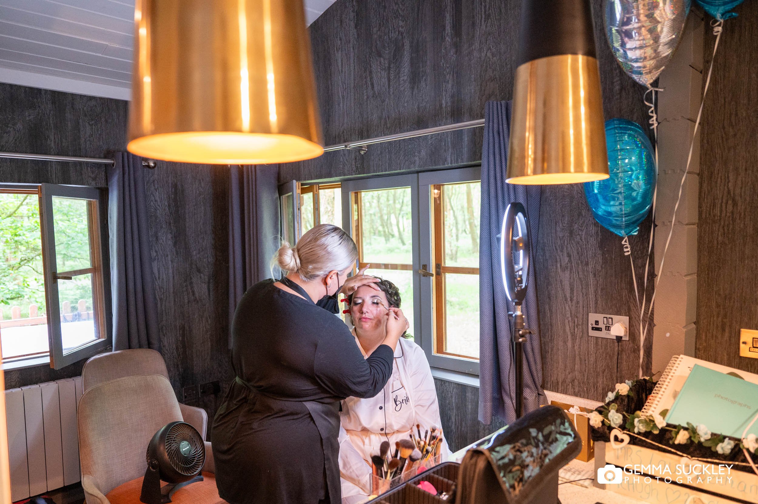 make up artist apply makeup to a bride at otley chevin hotel