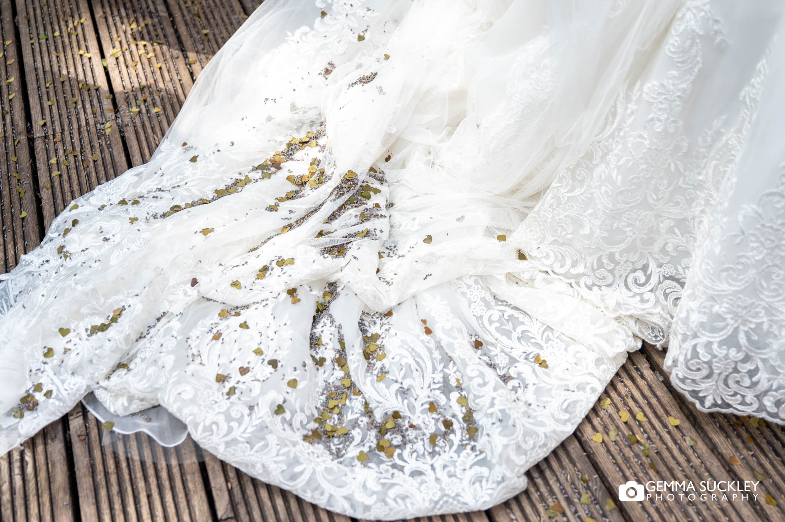 brides wedding dress covered in confetti