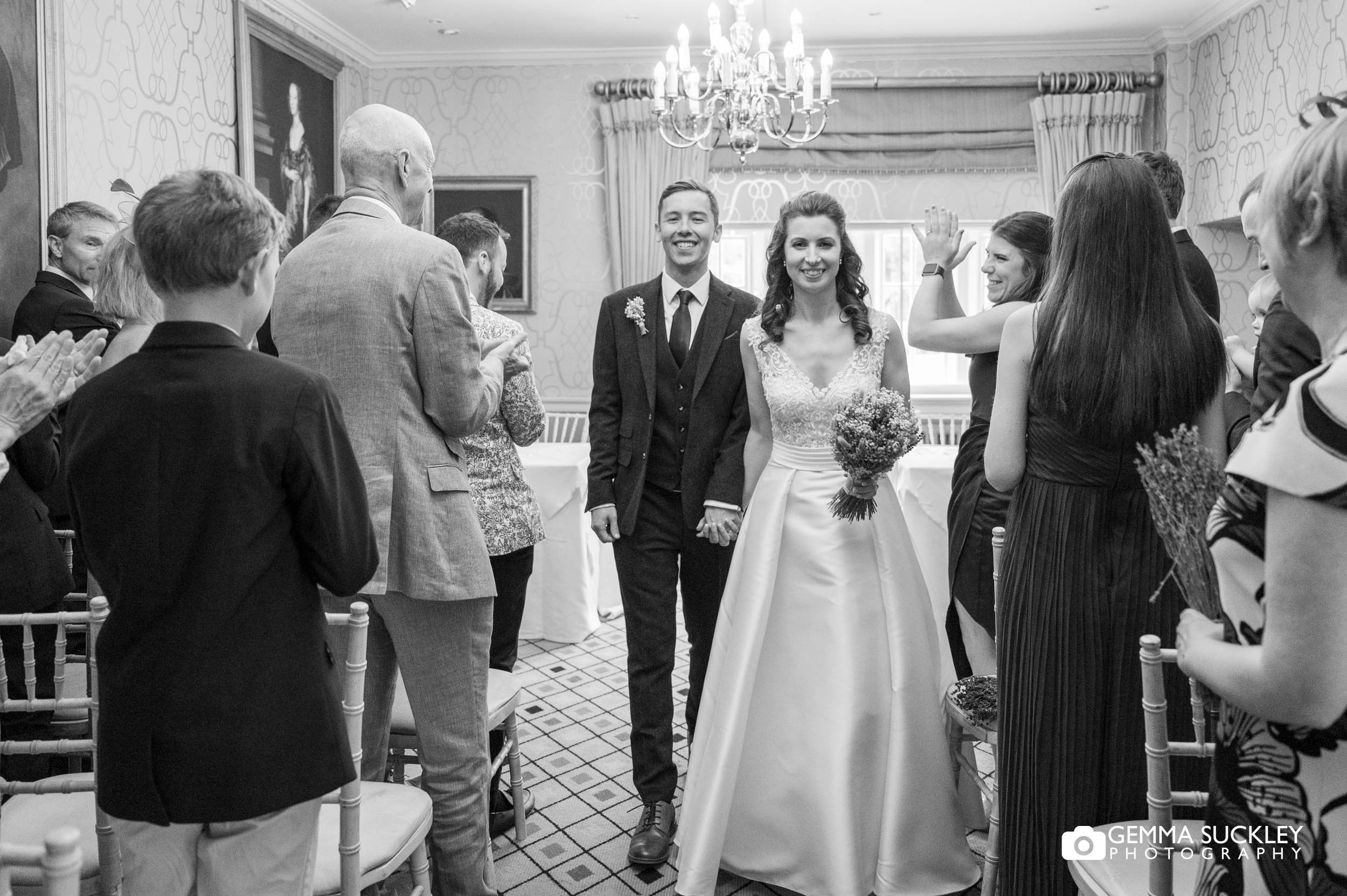 just married couple exiting the devonsire arms at bolton abbey